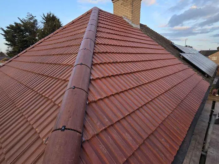Close-up of new ridge tiles on a red tiled roof